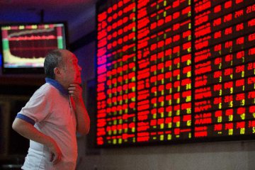 Chinese shares close higher Monday, set multiple records